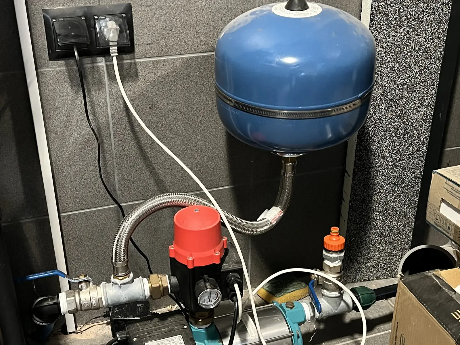 Zbiornik hydroforowy i pompa w kotłowni, widok szczegółowy podłączenia armatury